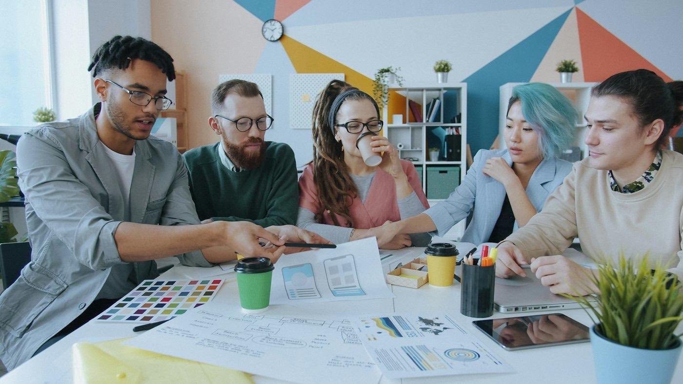 A software team reviewing designs together around a table